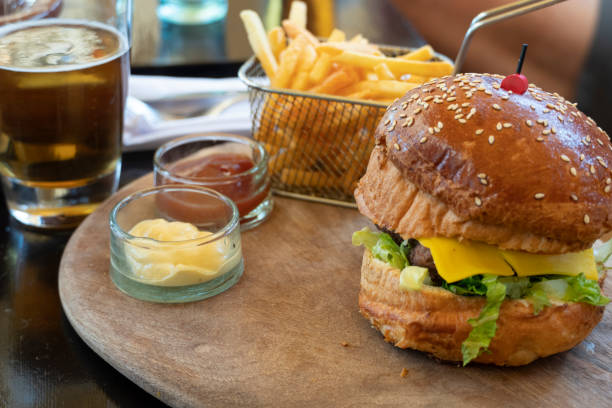 istock Hamburger with beer fries and sauces on board 1410509374
