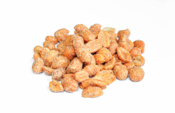 istock Pile of peanuts with chilli isolated on white background. Marinated nuts chili snack food 1410510314