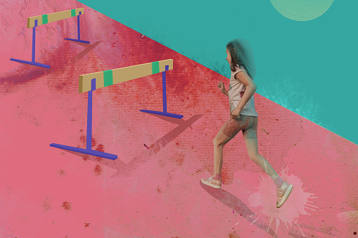 Confident girl jumping over hurdle. Abstract concept