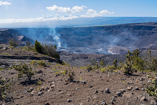 halema'uma'u crater of kilauea volcano emitting gas at hawaii volcanoes national park