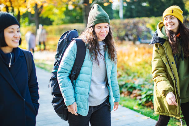 istock Female friends walking in autumn park 1410513996