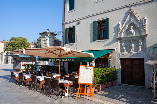 Venice, Italy - July 26, 2012: Regular outdoor small street café restaurant  in Venice.