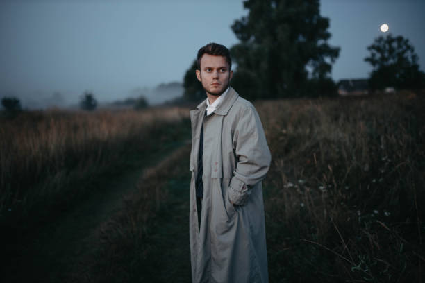 istock man thinker, philosopher poet walks in a raincoat across the field at dawn. The concept of existential crisis and loneliness. 1410514101