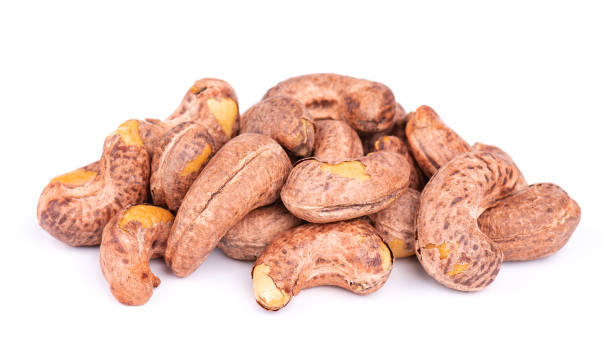 istock Cashew nuts in shell isolated on white background. Roasted and salted cashew nuts. 1410518076