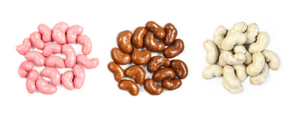 Piles of chocolate covered corn flips isolated on white background. Pink,black and white candy sweets. Delicious treats