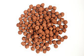 Group of round chocolate cornflakes isolated on white background. Brown crunchy food