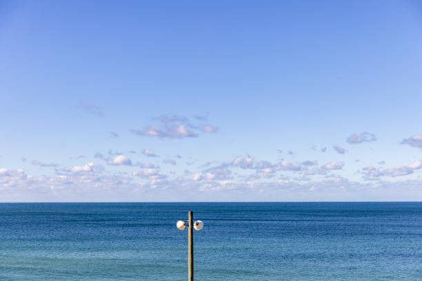 Surf life patrol loudspeaker against ocean water, background with copy space, full frame horizontal composition