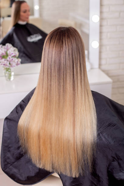 istock Female back with long straight blonde hair 1410520497