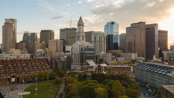 istock Boston evening skyline view with Financial district Custom Clock Tower, North Market, and Faneuil Hall Marketplace - aerial view from Trellis at Christopher Columbus Park. 1410522473