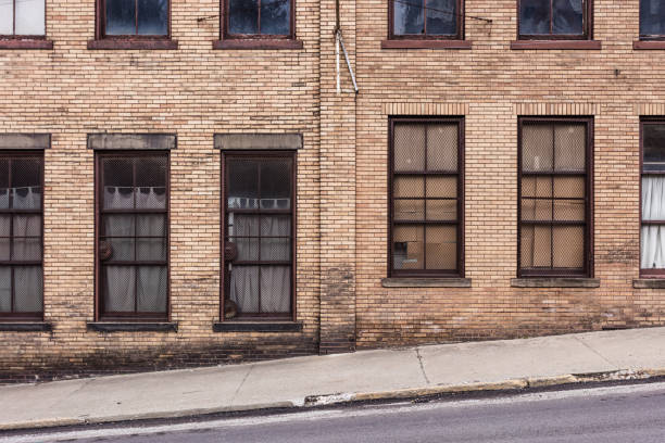 istock Side of vintage brick building with windows 1410522525