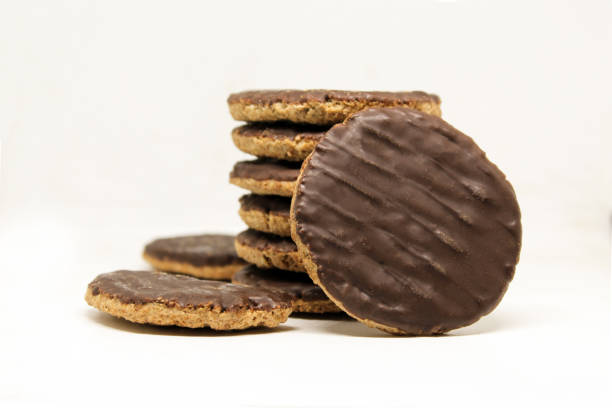 istock Chocolate coated whole wheat biscuits with added vitamins. Rounded cookies on white background isolated 1410522616
