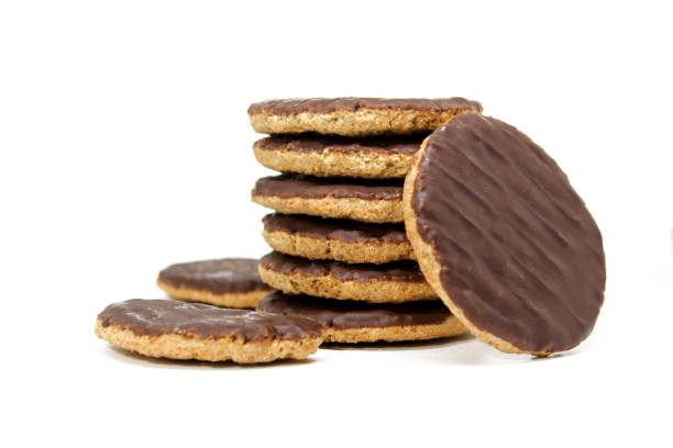 istock Chocolate coated whole wheat biscuits with added vitamins. Rounded cookies covered in chocolate on white background isolated 1410522659