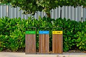 istock Modern wooden garbage bins for separate waste collection in public city park in Abu Dhabi,UAE. Urban ecology. Environmental care. 1410523259
