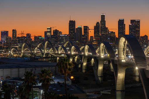 Los Angeles, CA - July 14 2022:  The new 6th street bridge in Los Angeles viewed at sunset with the skyline in the distance