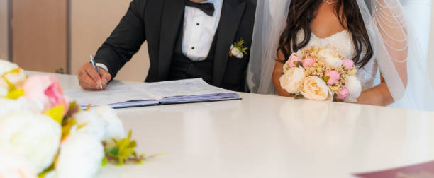 istock bride and groom sign at the wedding ceremony 1410528892