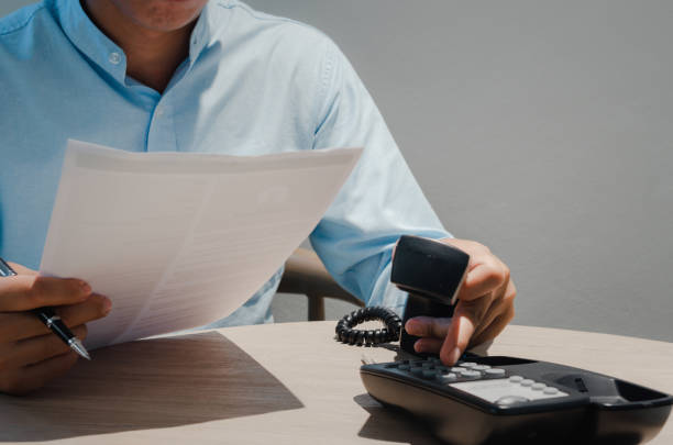 istock business people use phone and hold business documents for big data analysis marketing planning. 1410536562