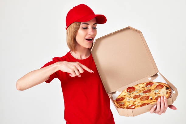 istock pizza delivery girl pointing finger to pizza on white background 1410536631