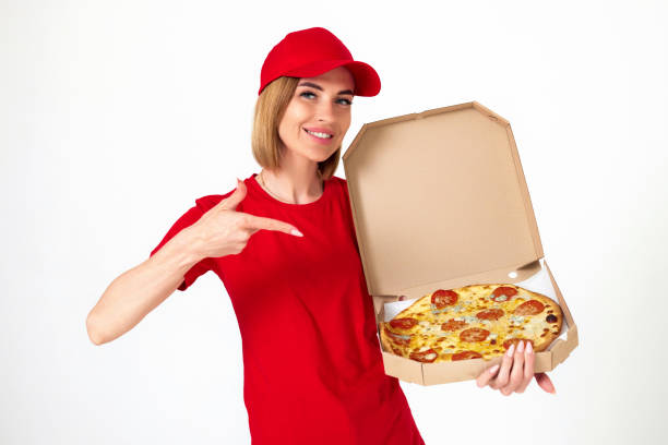 istock pizza delivery girl pointing finger to pizza on white background 1410536637