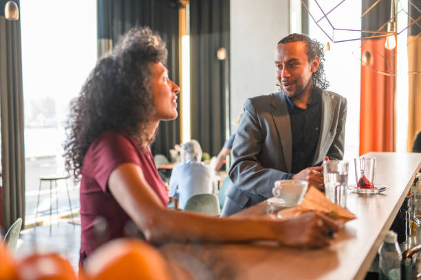 istock Hispanic Coworkers During A Conversation In A Cafe 1410537127