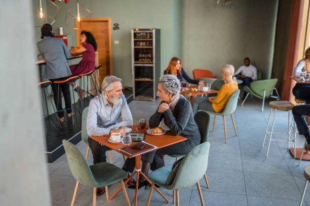 istock Business Colleagues Enjoying Coffee Break At Cafe 1410537141
