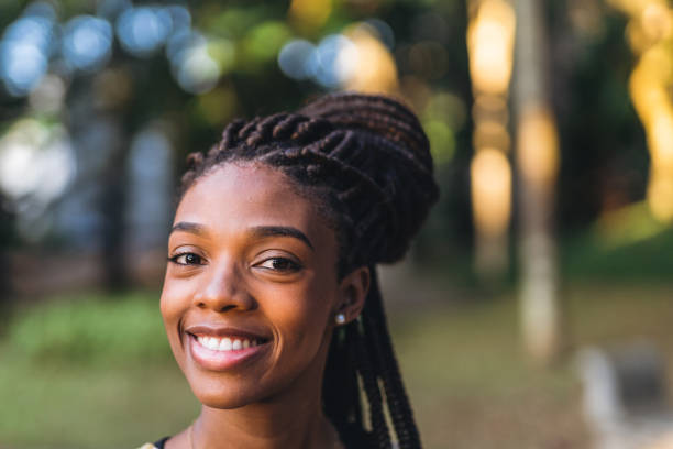 istock Smiling afro woman in public park 1410538832