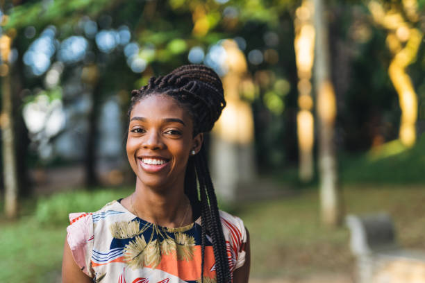 istock Smiling afro woman in public park 1410538842