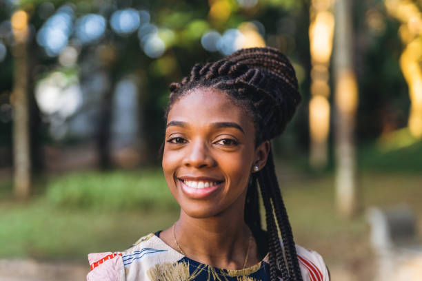 istock Smiling afro woman in public park 1410538847