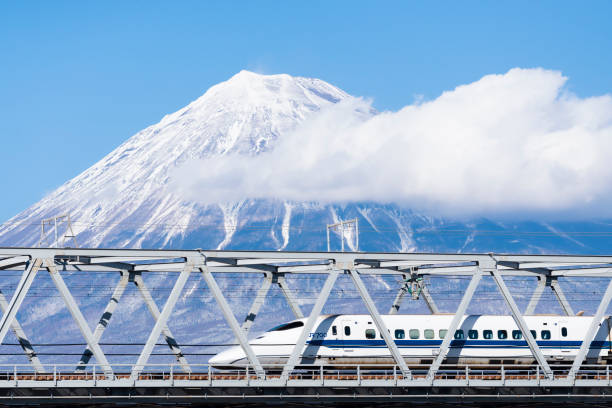 High Speed Bullet Train Shinkansen with Fuji mountain background, Shizuoka, Japan Japan - February 1, 2019 : High Speed Bullet Train Shinkansen running on railway bridge across Fuji river with Fuji mountain background in winter, Fuji city, Shizuoka bullet train mount fuji stock pictures, royalty-free photos & images