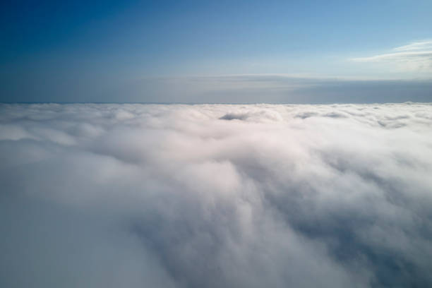 istock Aerial view from high altitude of earth covered with puffy rainy clouds forming before rainstorm 1410549324