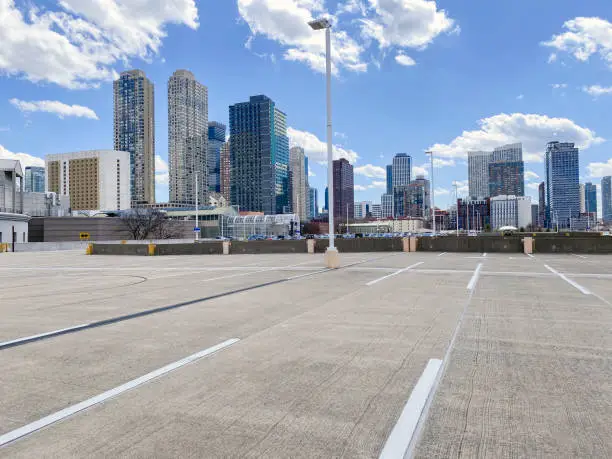 Empty parking lot in front of a cityscape