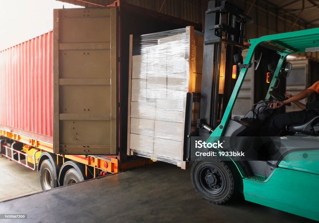Loading Packaging Forklift Tractor Loading Packaging Boxes Into Shipping Container Trucks ...