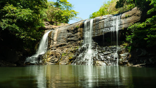 istock A tropical waterfall in a mountain canyon surrounded by jungle. Sri Lanka. 1410570545