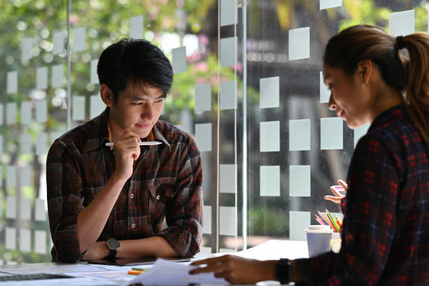 istock Asian business handsome man looking thoughtful holding a digital pen while brainstroming idea about media development in Ux Ui topics. Business and technology development concepts. 1410572794