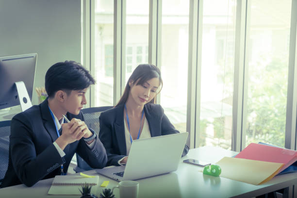 istock Two Business people is discussing work on notebook laptop in office with serious gesture. 1410572889