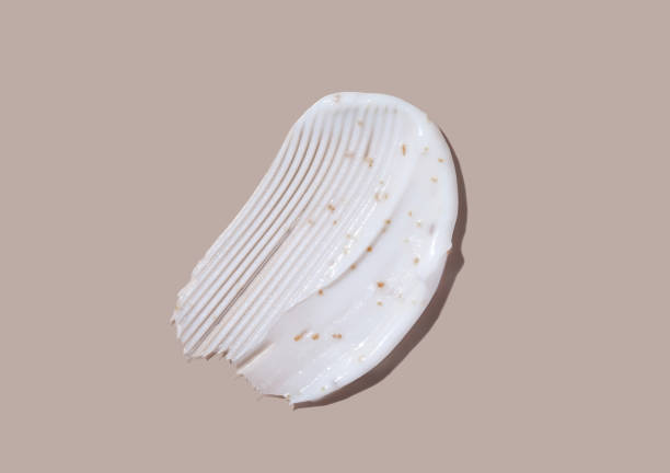 istock Scrub cream swatch smear smudge on brown color background. 1410576273