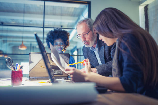 istock Team of architects working on a new business projects. Senior team leader leading the project 1410580772