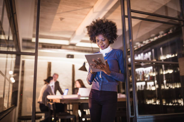 istock Female Leaders. Young African-American woman architect using digital tablet in front of architecture studio. 1410580787