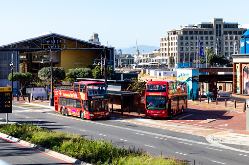 Cape Town, South Africa - June 25 2022: Red Cape Town open-topped red sightseeing buses parked at V & A Waterfront.