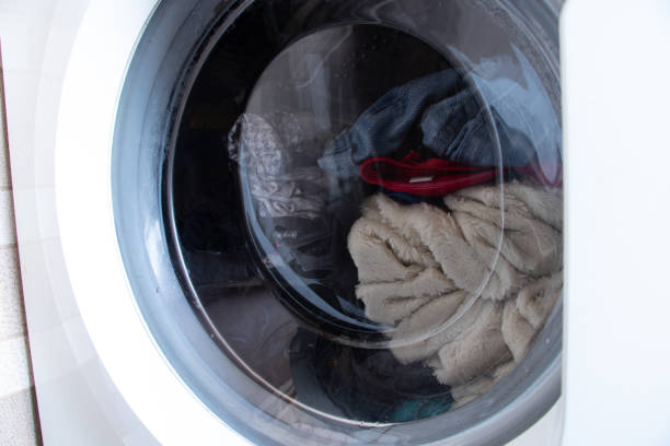 dirty old washing machine with things, washing clothes in a washing machine, washing