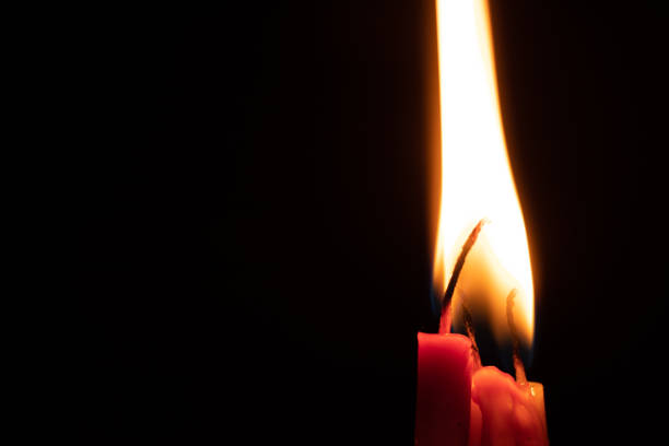 istock candle fire in the dark, burning candle flame 1410582603