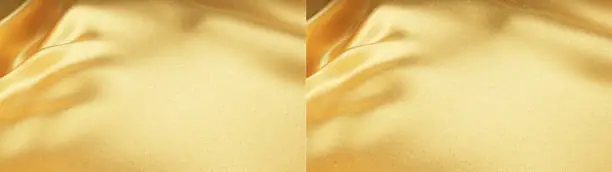 3D Illustration.Gorgeous golden cloth-like background image. Set with and without rays of light.