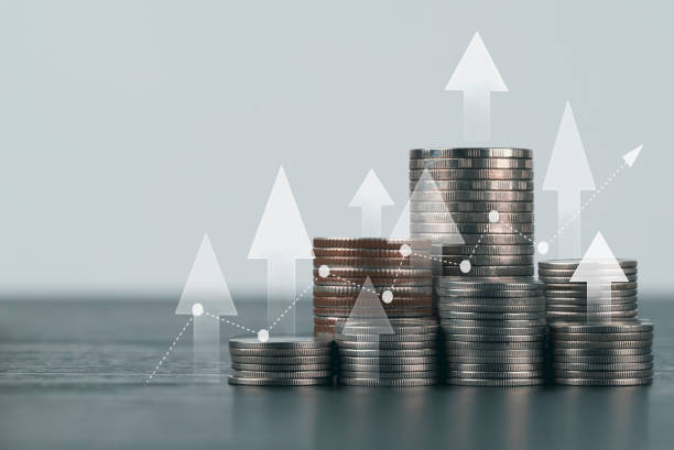istock Coin stack with growth chart and graph progress , Market finance and Investments growing with businessman investor , finance and business concept 1410585350