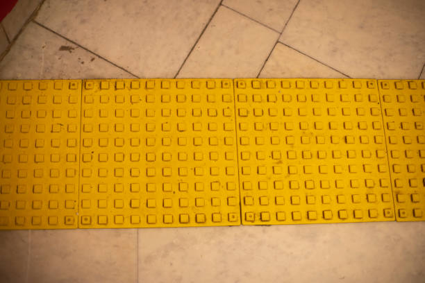Surface for visually impaired. Yellow limiter for blind. Markings on stairs. Steps in building. Infrastructure for people with disabilities.