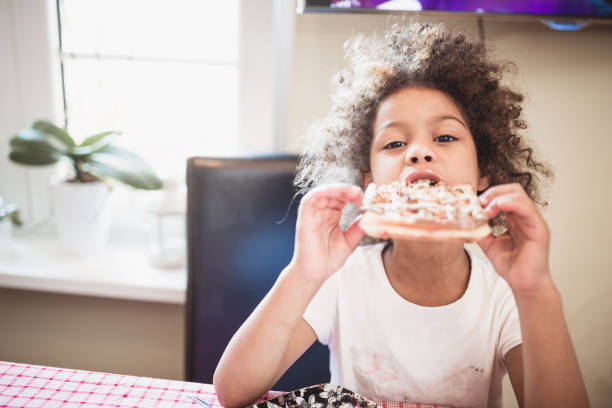 istock Little mixed race girl having a breakfast 1410586543