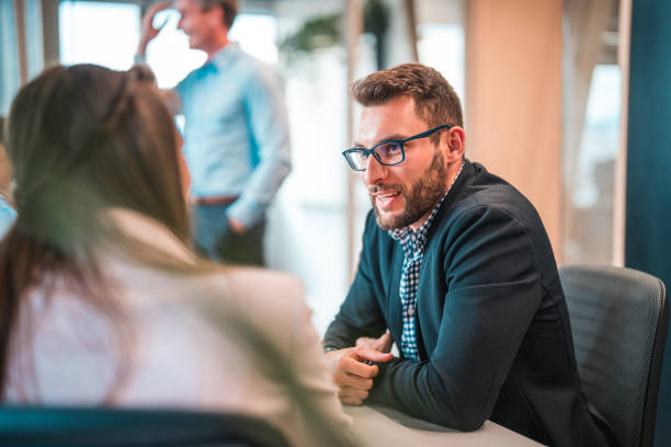 young male lawyer in a business meeting with a female client - vanity business business person men imagens e fotografias de stock