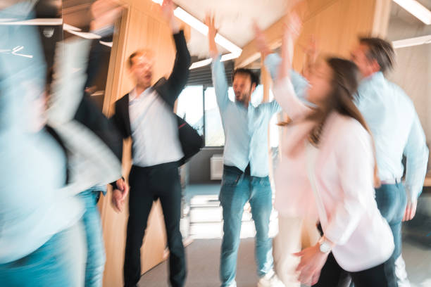 istock Mixed Age Range Multiracial Colleagues Celebrating With Energy And Joy At The Office 1410589140