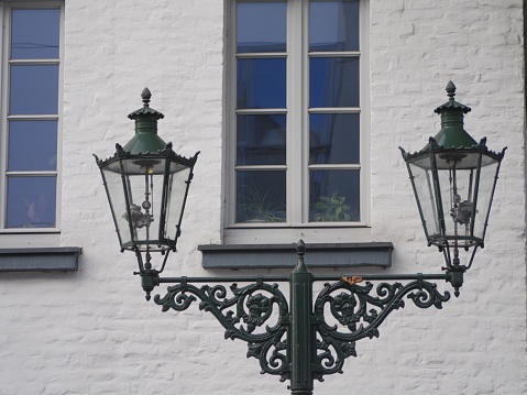 Old gas lanterns in Kaiserswerth Germany well maintained and still used ,in front of a withe house wall