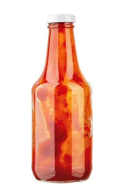 Photo of Open bottle of ketchup on isolated with white background. File contains clipping path.