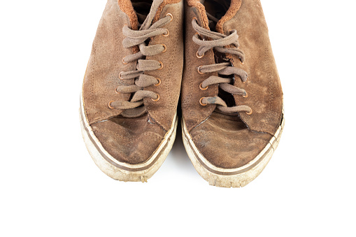 A pair of worn, vintage styled, classic sneakers isolated on white background. File contains clipping path.