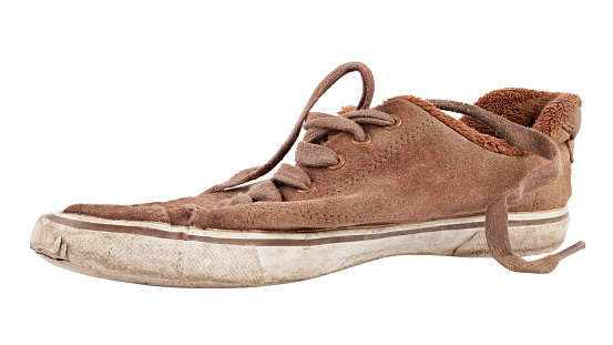 Old and dirty canvas sneakers isolated on white background. File contains clipping path.